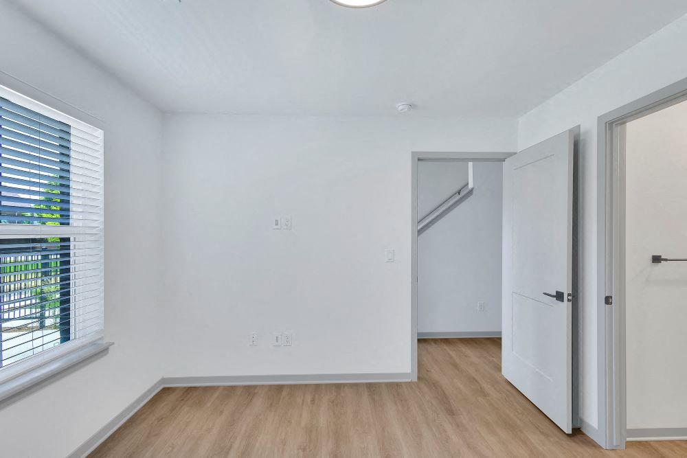 First floor bedroom with large window and full bath